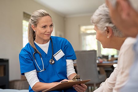Friendly healthcare professional consulting elderly patient in a medical clinic, emphasizing compassionate care, patient engagement, and medical advice for seniors.